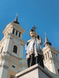 Low angle view of statue outside church