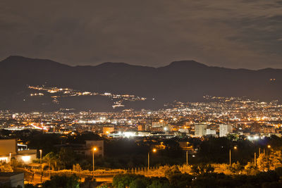 High angle view of illuminated buildings in city at night