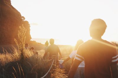 Silhouette of people on beach at sunset