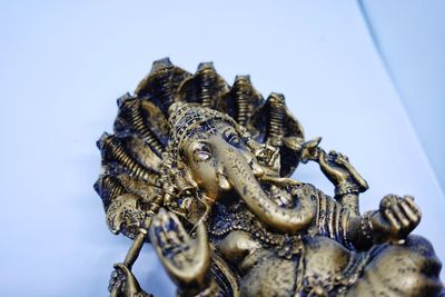 Low angle view of statue against blue sky