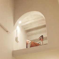 Woman standing by staircase in building