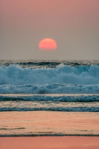 Scenic view of sea against clear sky during sunset