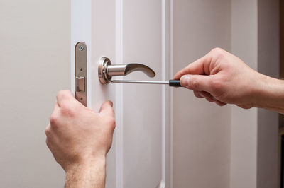 Midsection of man holding door