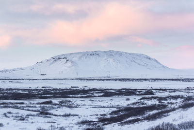 Scenic view of snowcapped mountains against sky during sunset