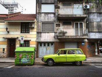 Car parked on street against building