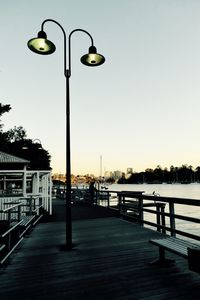 Illuminated street light against clear sky