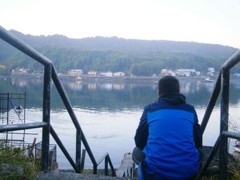 Rear view of man looking at lake