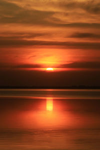 Scenic view of sea against orange sky during sunset
