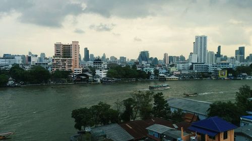 Cityscape against cloudy sky