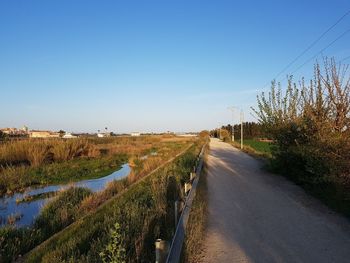 Empty road along countryside landscape