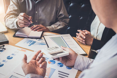 Cropped image of business people working in office