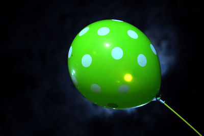 Close-up of illuminated lights against black background