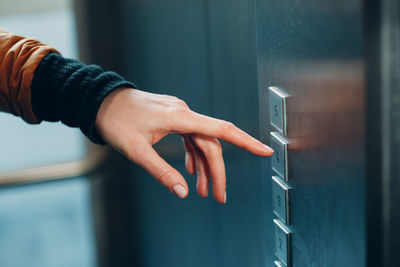 Close-up of hand on metal door