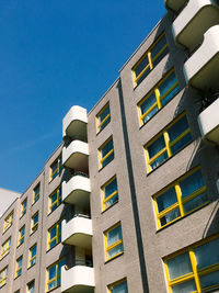 Low angle view of building façade against clear blue sky