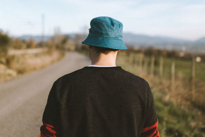 Rear view of a man standing on road