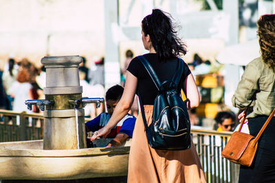 Rear view of people standing outdoors