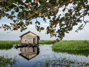 Built structure by lake against clear sky