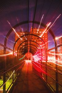 Rear view of man walking in tunnel