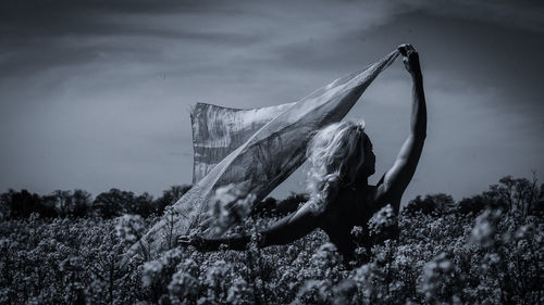 Close-up of animal skull on field against sky