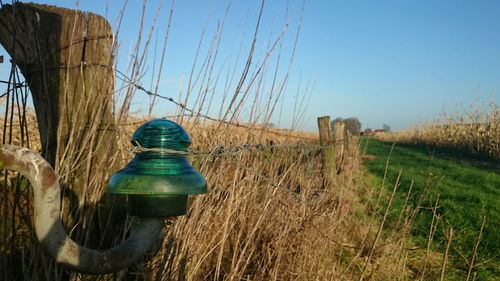 View of field against clear blue sky