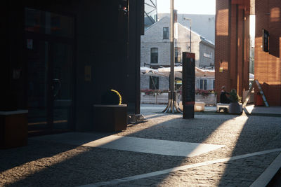 Street amidst buildings during sunny day