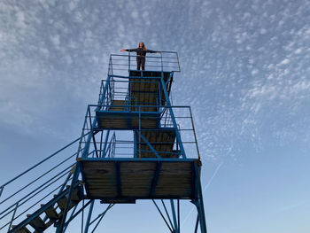 Low angle view of women on the top of beach tower