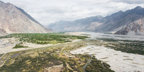 Scenic view of landscape and mountains against sky