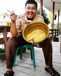 Portrait of happy man sitting at restaurant