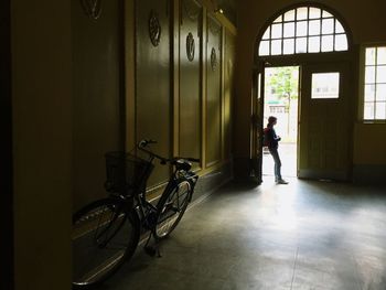 Girl standing on doorway of hall