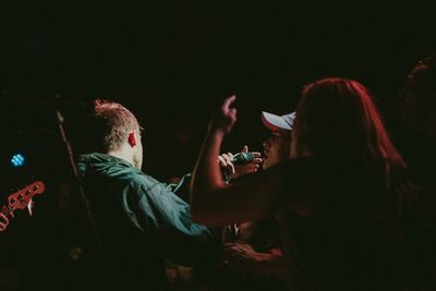 Rear view of people playing music concert