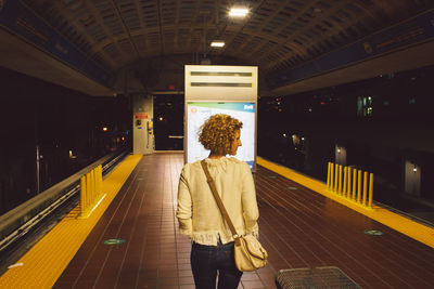 Rear view of woman standing in city