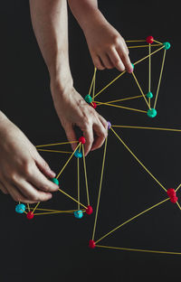 Mother and son making geometric shapes from sticks and play dough.