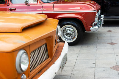 Several cars of different makes and models are seen at an exhibition of old cars