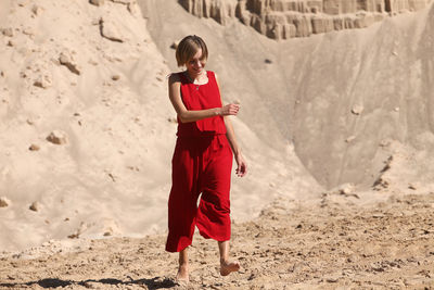 Full length of woman standing on sand