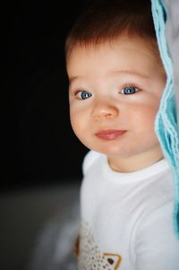 Close-up portrait of cute baby boy with blue eyes