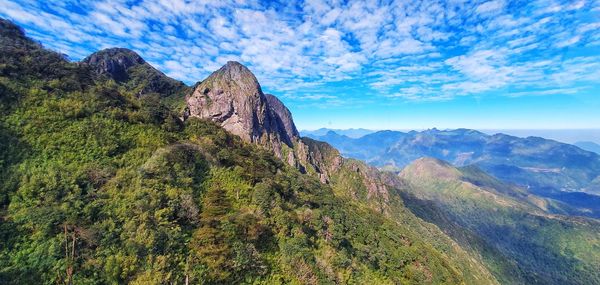 Scenic view of mountains against blue sky