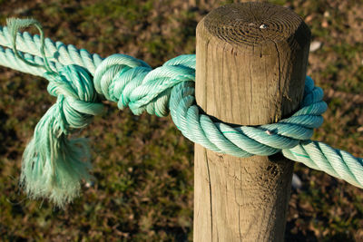 Close-up of rope tied on wooden post