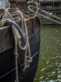 Close-up of ropes tied on boat in lake