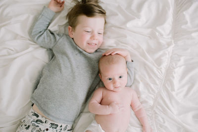 High angle view of baby lying on bed