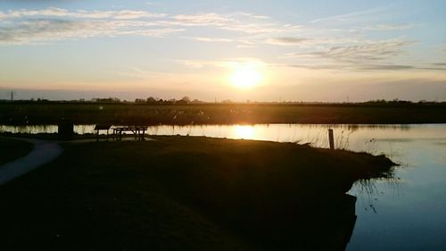 Scenic view of lake against sky during sunset