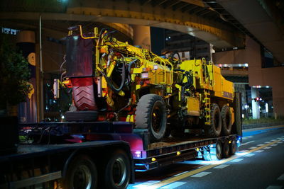Vehicles on road in city at night