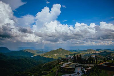 Panoramic view of houses and mountains against sky