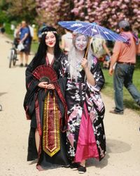 Full length portrait of young woman with umbrella