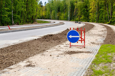 Road sign by trees