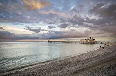 Scenic view of beach against sky during sunset