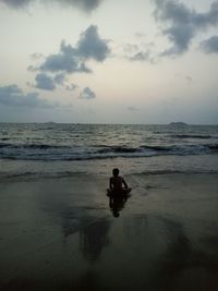 Man standing on beach against sky