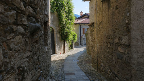 Narrow footpath amidst old buildings