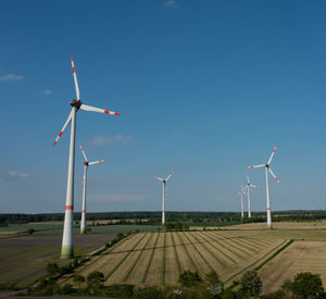 Windmill on field against sky