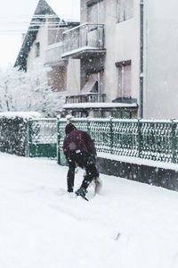 Man walking on snow in city