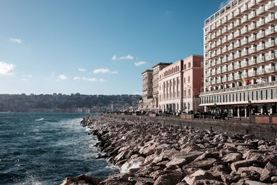 View of beach and buildings against sky